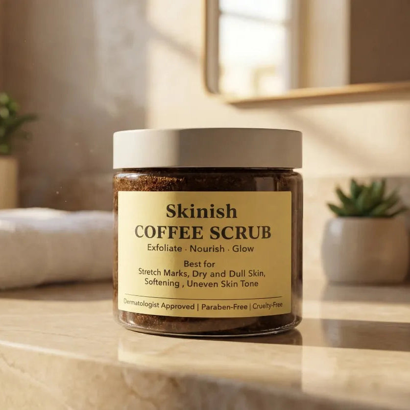 Jar of Skinish Coffee Scrub on a bathroom counter with towels and plants in the background